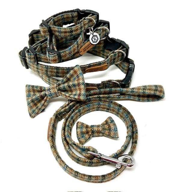 A set of dog accessories including a check tweed collar, lead, and bow tie arranged neatly on a white background.