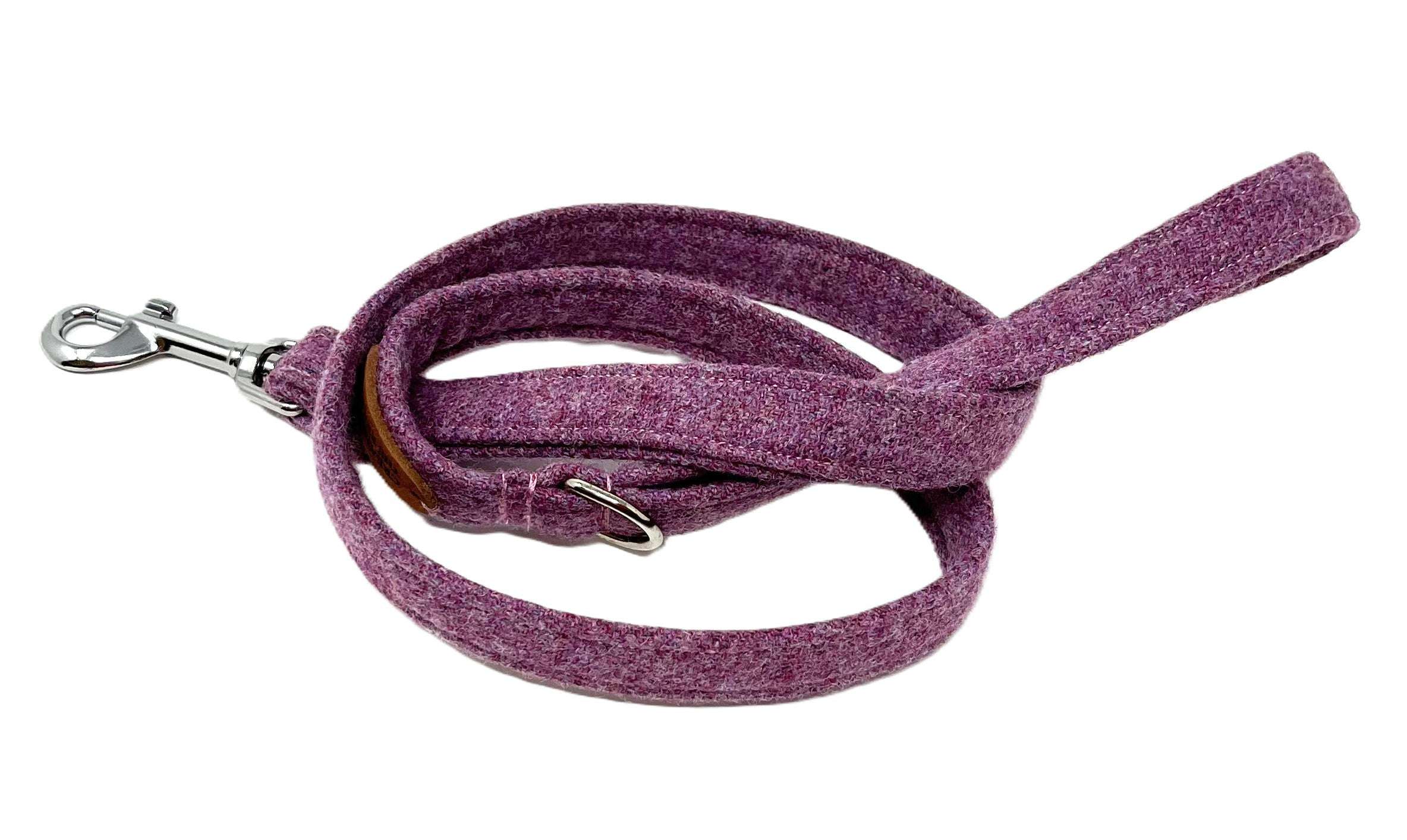 Purple dog leash with metal clip on a white background