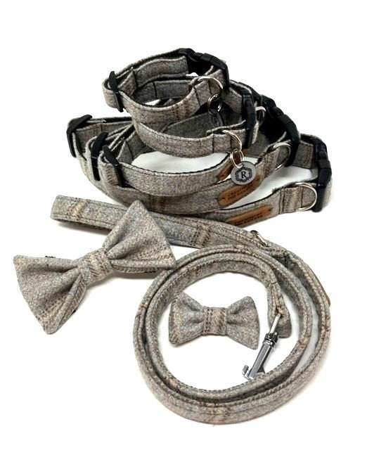 Selection of grey collars, leads and bow ties on a plain white background