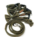 A set of dark moss green herringbone tweed dog accessories including a collar, lead, and bow tie laid out on a white background.