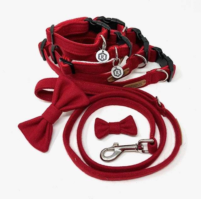A set of British tweed dog collar, lead, and bow tie in red, displayed on a white background.